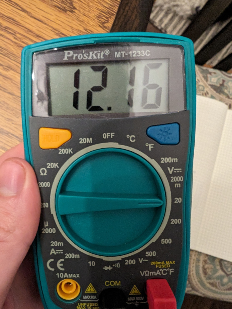 A voltmeter showing 12V
